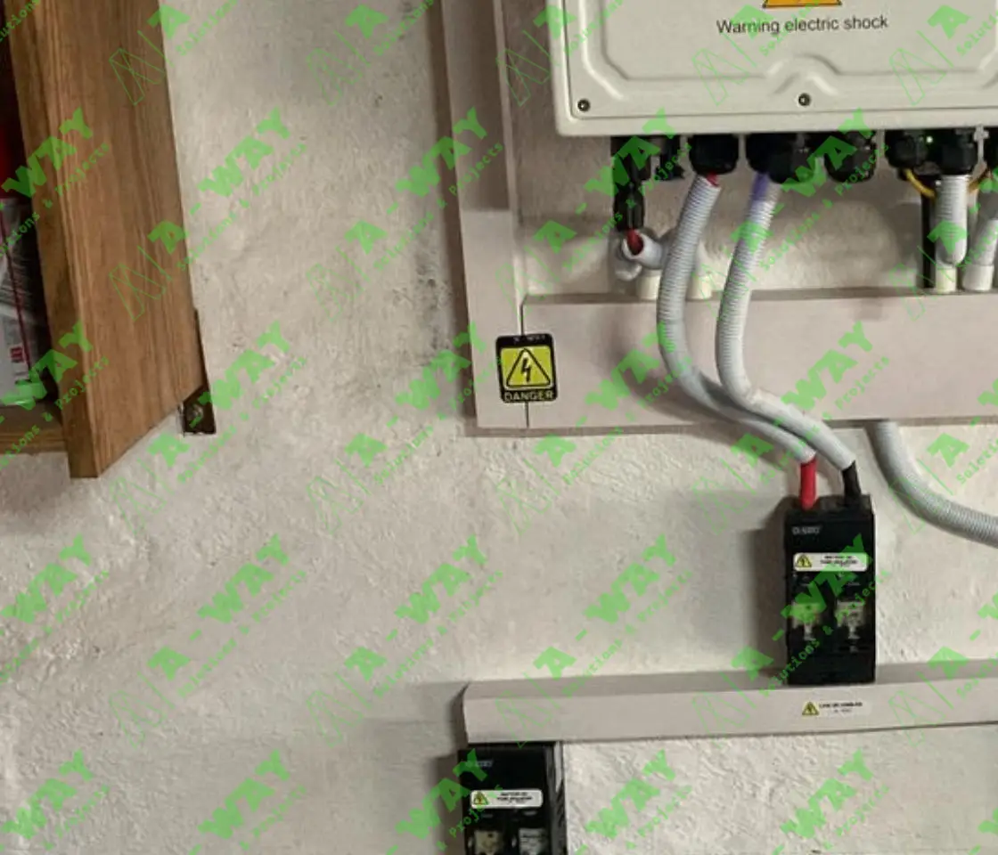 Solar inverter and electrical equipment with warning labels.
